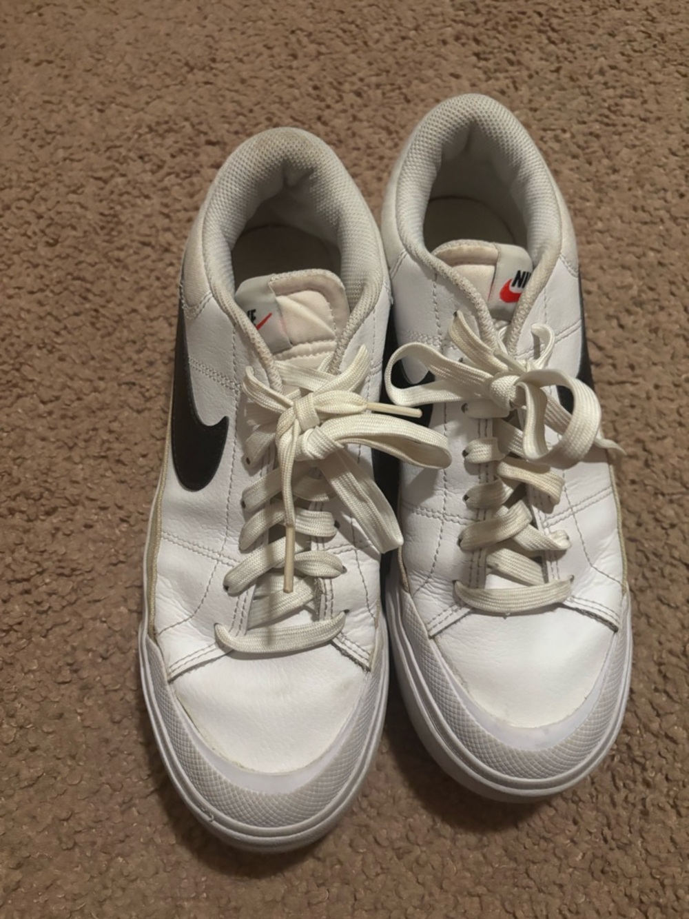 Nike White Leather Sneakers with Black Swoosh and Red Tongue Logo
